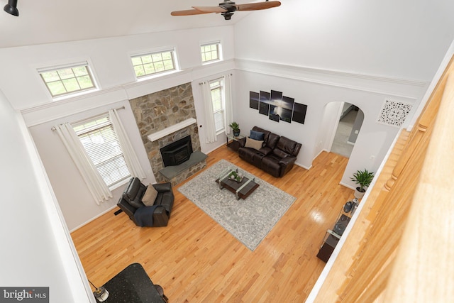 189 Potomac Crossing St, Charles Town, WV 25414 - living area with a towering ceiling, a fireplace, ceiling fan, wood finished floors, and arched walkways