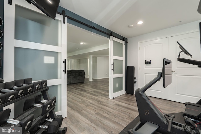 189 Potomac Crossing St, Charles Town, WV 25414 - workout room with a barn door, wood finished floors, recessed lighting, and baseboards