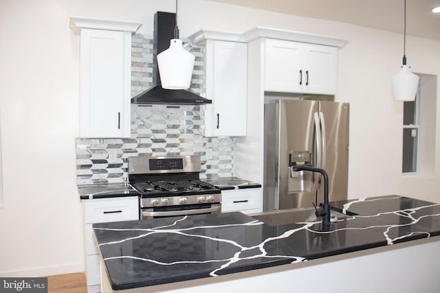 kitchen with white cabinetry, tasteful backsplash, appliances with stainless steel finishes, dark countertops, and wall chimney exhaust hood