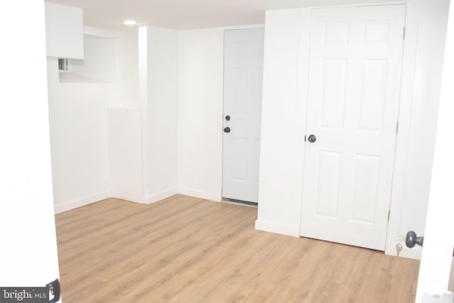 spare room with light wood-style flooring and baseboards