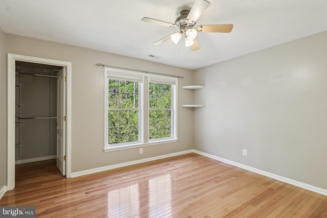 24 Monument Dr, Stafford, VA 22554 - unfurnished bedroom featuring a closet, baseboards, a walk in closet, and light wood-type flooring