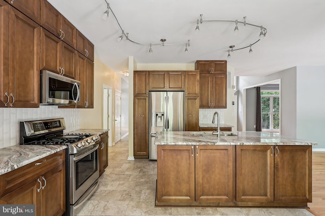24 Monument Dr, Stafford, VA 22554 - kitchen featuring a kitchen island with sink, baseboards, light stone counters, appliances with stainless steel finishes, and backsplash