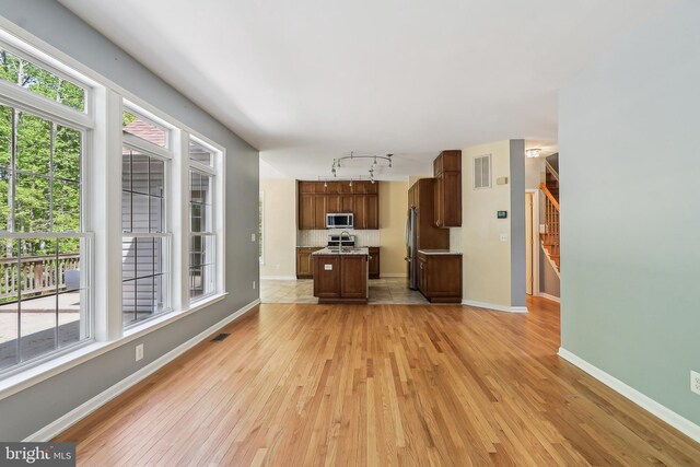 24 Monument Dr, Stafford, VA 22554 - unfurnished living room featuring visible vents, track lighting, stairs, baseboards, and light wood-style flooring