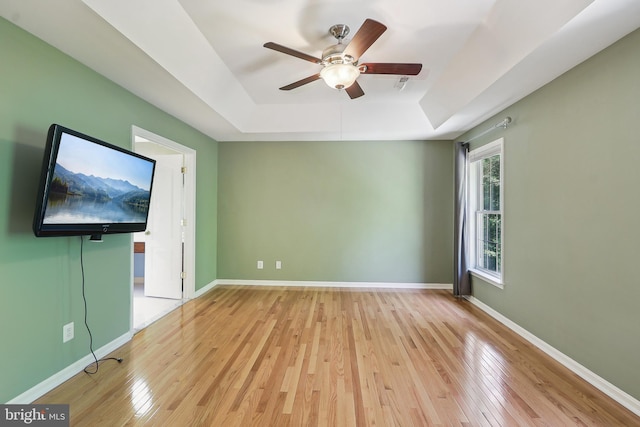 24 Monument Dr, Stafford, VA 22554 - spare room featuring baseboards, ceiling fan, a tray ceiling, and light wood-type flooring