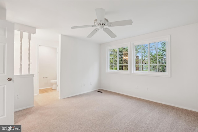 spare room featuring baseboards, visible vents, ceiling fan, and carpet flooring