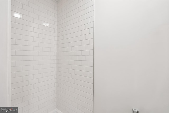 bathroom with tiled shower