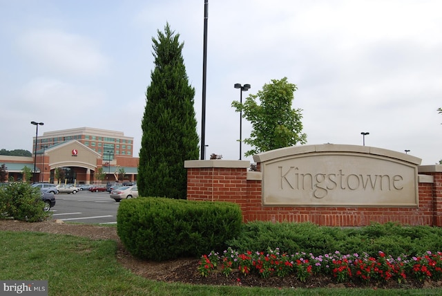 community sign featuring uncovered parking