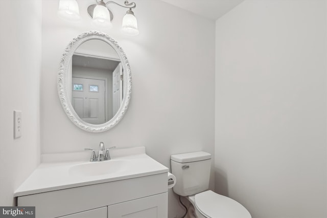 bathroom with toilet and vanity