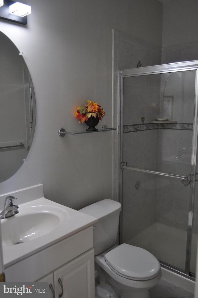 full bath featuring a shower stall, toilet, and vanity