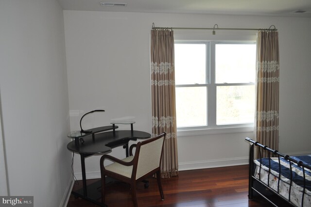 bedroom featuring baseboards, visible vents, and wood finished floors
