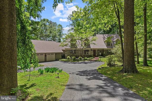 3 Hickory Ln, Chadds Ford, PA 19317 - view of front facade with asphalt driveway, a shingled roof, and a garage