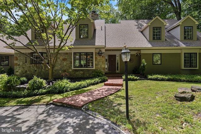 3 Hickory Ln, Chadds Ford, PA 19317 - cape cod-style house featuring stone siding, a front yard, a chimney, and a shingled roof