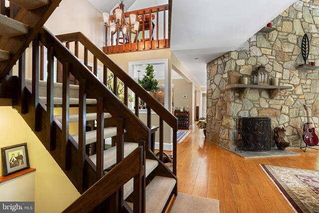 3 Hickory Ln, Chadds Ford, PA 19317 - stairway with wood finished floors, a chandelier, lofted ceiling, and a fireplace