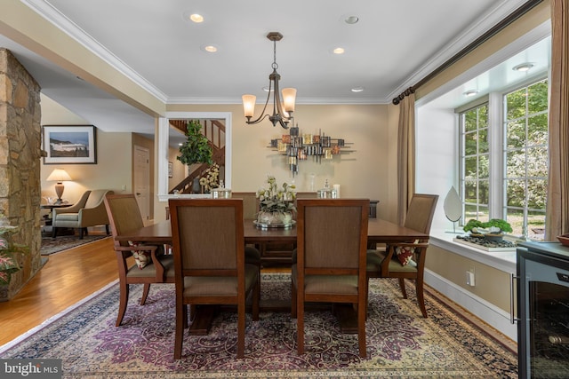 3 Hickory Ln, Chadds Ford, PA 19317 - dining area with wine cooler, a chandelier, ornamental molding, wood finished floors, and recessed lighting