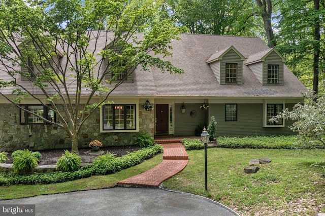 3 Hickory Ln, Chadds Ford, PA 19317 - new england style home with stone siding, a front yard, a porch, and roof with shingles
