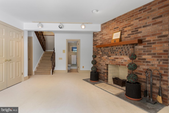 3 Hickory Ln, Chadds Ford, PA 19317 - carpeted living area with stairway, track lighting, baseboards, and a fireplace