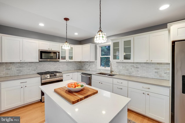 2314 Apple Hill Rd, Alexandria, VA 22308 - kitchen featuring stainless steel appliances, light countertops, white cabinets, backsplash, and a sink