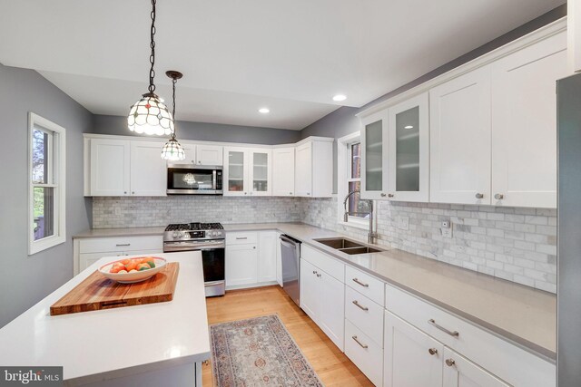 2314 Apple Hill Rd, Alexandria, VA 22308 - kitchen featuring stainless steel appliances, light countertops, white cabinets, and a sink