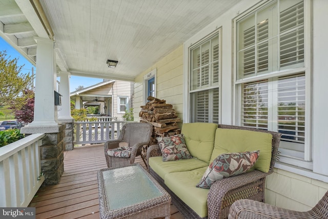balcony with a porch and an outdoor living space