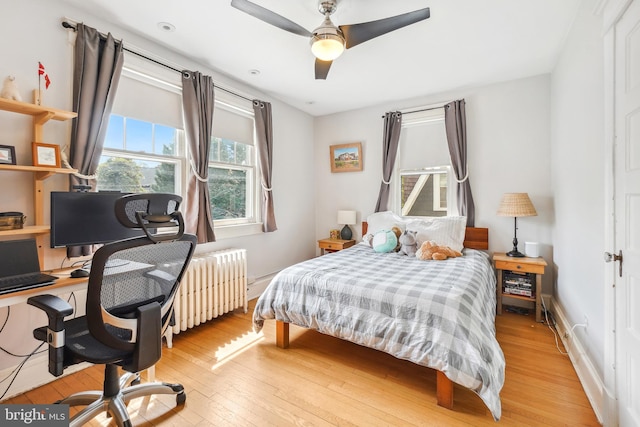bedroom with light wood-style floors and radiator heating unit