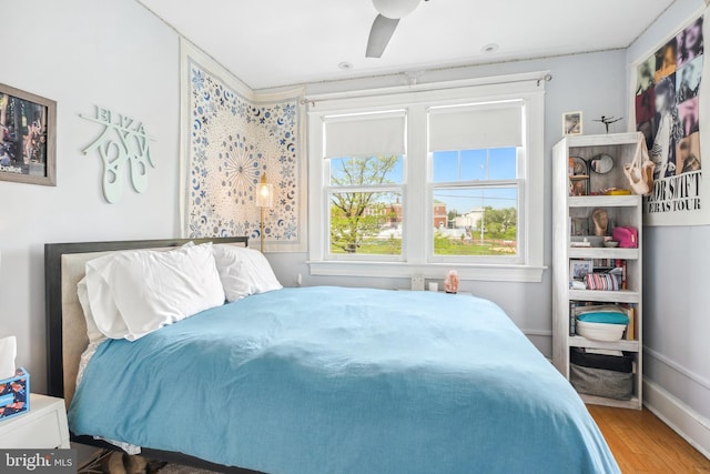 bedroom featuring a ceiling fan and wood finished floors