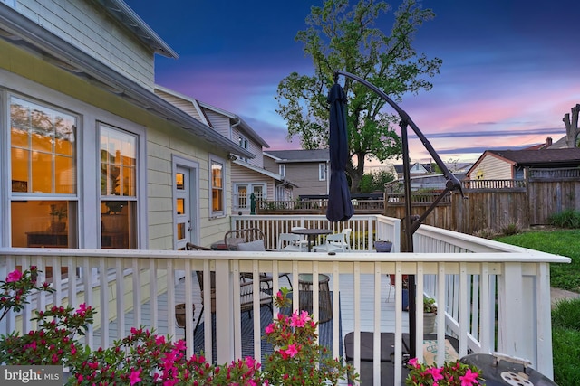 deck at dusk with fence