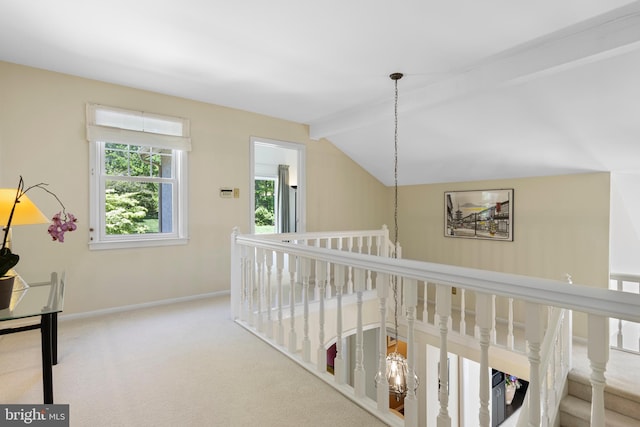 hallway with an upstairs landing, carpet flooring, and baseboards