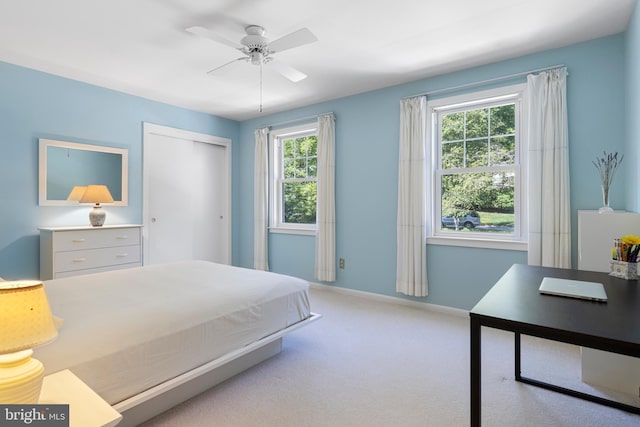 bedroom featuring carpet flooring, a closet, baseboards, and ceiling fan