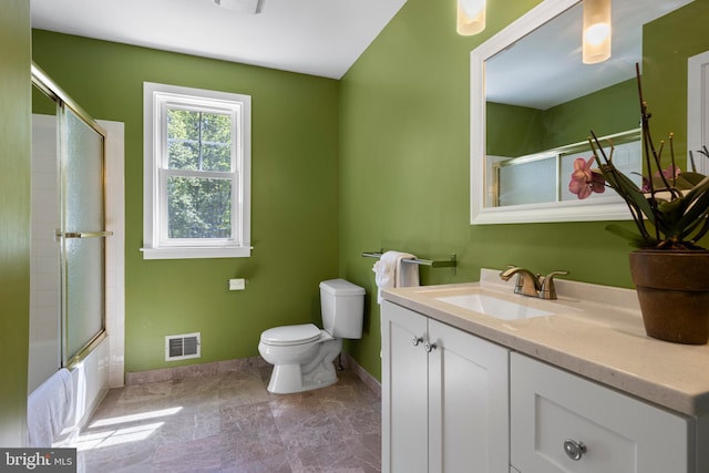 bathroom featuring baseboards, toilet, vanity, and combined bath / shower with glass door
