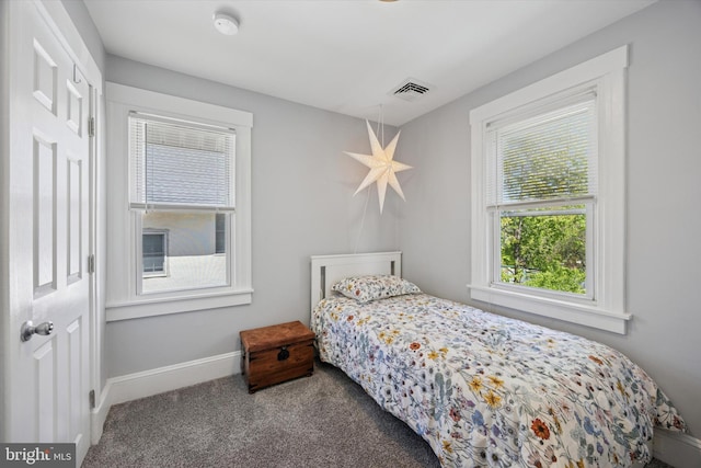bedroom featuring baseboards, carpet flooring, and visible vents