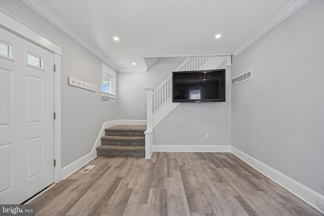 interior space with stairway, baseboards, wood finished floors, and visible vents
