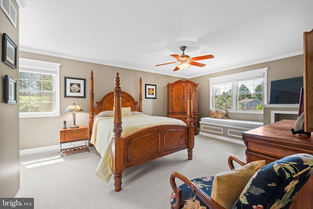 bedroom with baseboards, ornamental molding, light colored carpet, and visible vents