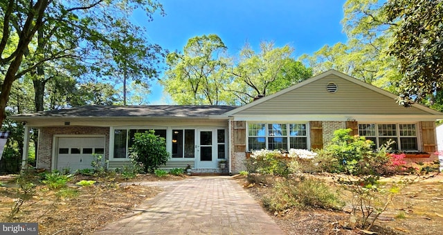 ranch-style house featuring brick siding and an attached garage