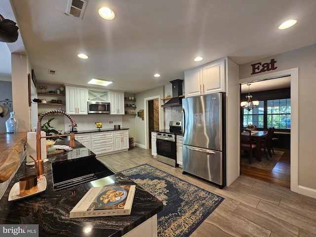 kitchen featuring wall chimney range hood, dark countertops, open shelves, and stainless steel appliances