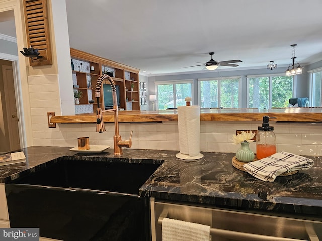 kitchen featuring crown molding, decorative backsplash, ceiling fan, a sink, and dishwasher