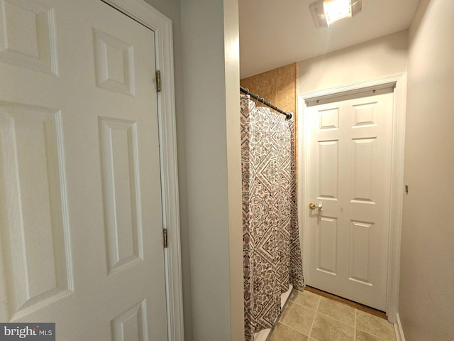 bathroom featuring visible vents, curtained shower, and tile patterned flooring