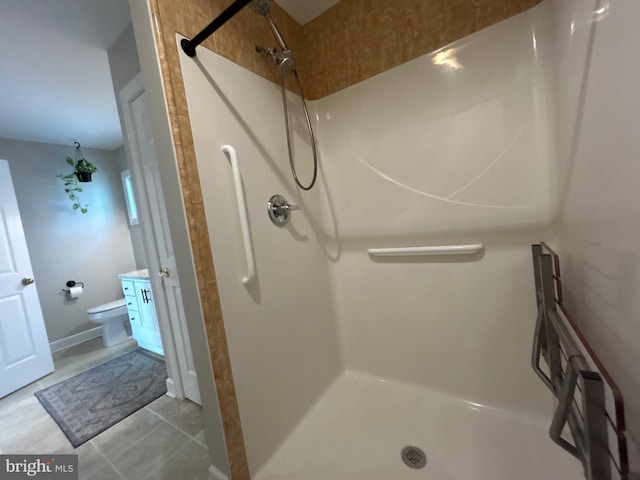 full bathroom with toilet, a shower stall, and tile patterned flooring