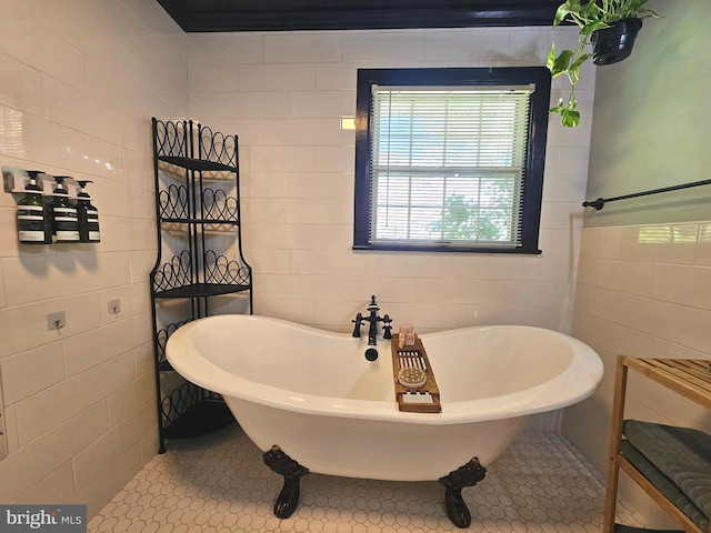 full bath featuring tile patterned floors, a freestanding bath, and tile walls