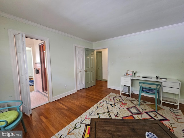bedroom featuring baseboards, ornamental molding, and wood finished floors
