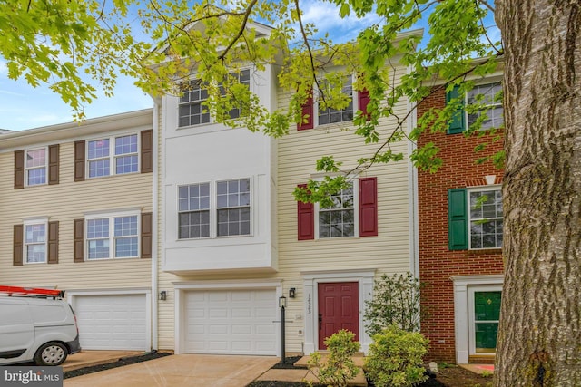 multi unit property with driveway and an attached garage