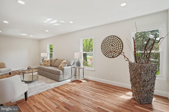 living room with recessed lighting, baseboards, and wood finished floors