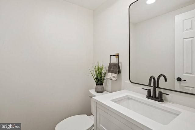 bathroom with toilet and vanity