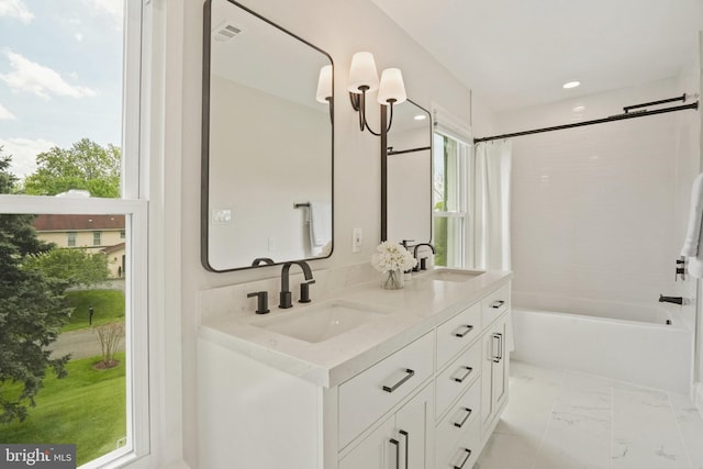 full bathroom with visible vents, a sink, shower / tub combination, and double vanity
