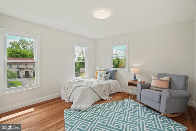 bedroom with baseboards and light wood-style floors