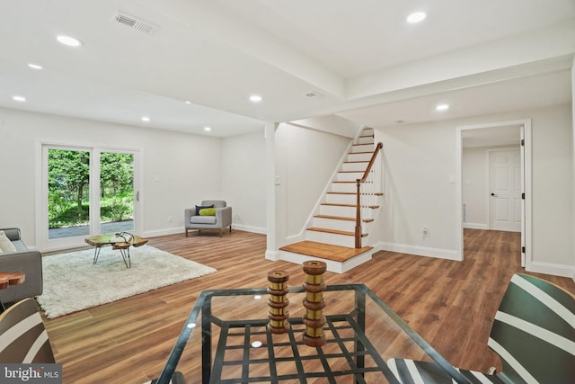 living room with stairs, recessed lighting, baseboards, wood finished floors, and visible vents