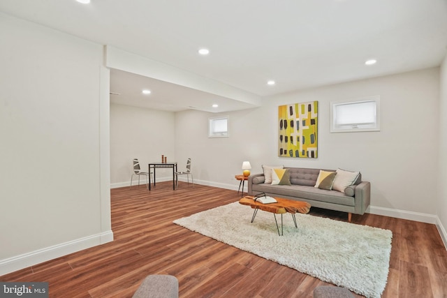 living area featuring a healthy amount of sunlight, baseboards, recessed lighting, and wood finished floors