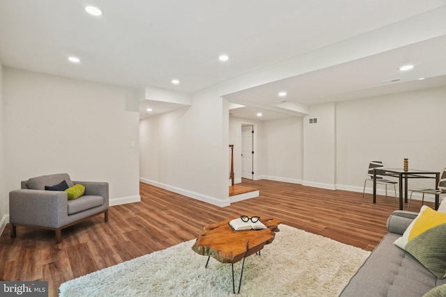 living area with baseboards, recessed lighting, wood finished floors, and visible vents