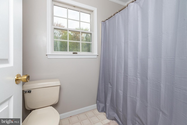 bathroom with tile patterned floors, toilet, and baseboards