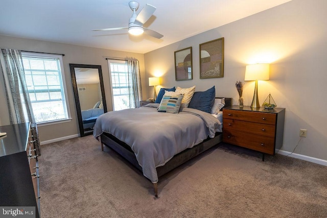 bedroom featuring ceiling fan, light carpet, and baseboards