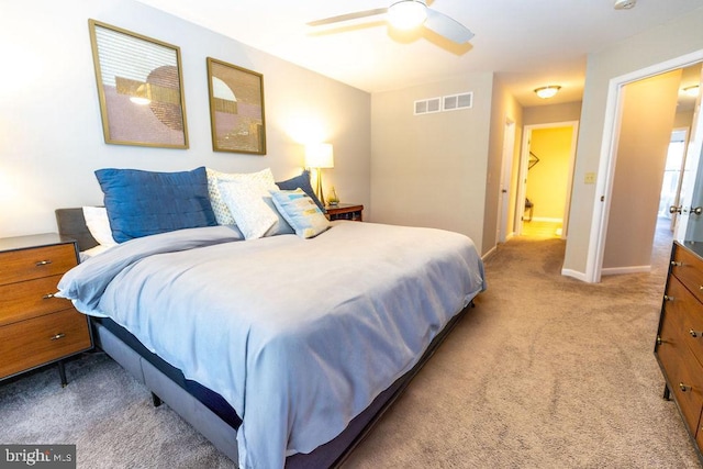 bedroom featuring visible vents, baseboards, a ceiling fan, and carpet floors